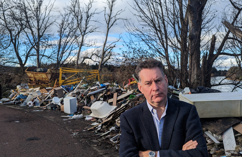 Murdo Fraser MSP beside fly-tipping near the River Tay