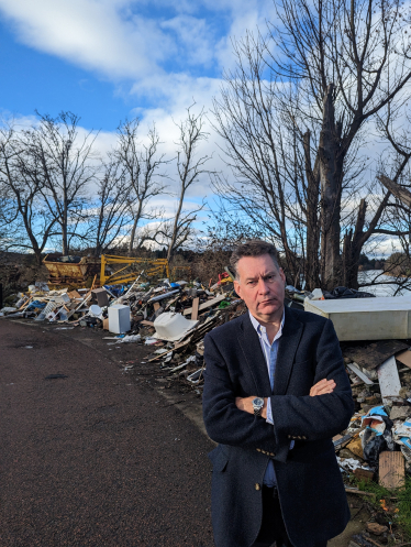 Murdo Fraser MSP beside fly-tipping near the River Tay